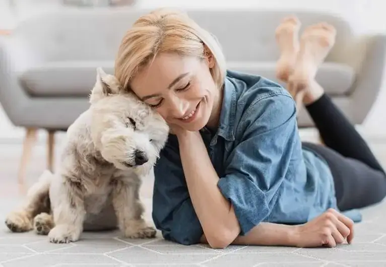 Woman relaxing with a small dog for pet care
