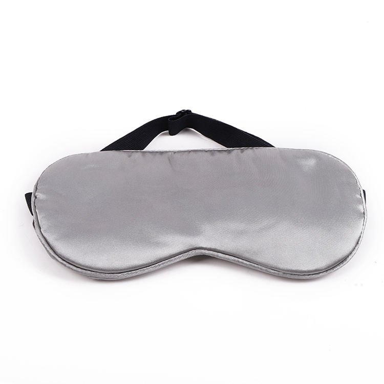 Gray fabric-covered eye mask with an adjustable black strap