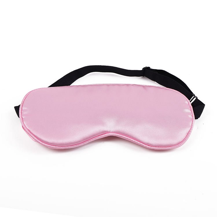 Pink fabric-covered eye mask with a black adjustment strap