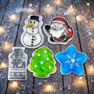 Snowman Santa bottle tree and star heat-pack designs in a seasonal supplier display