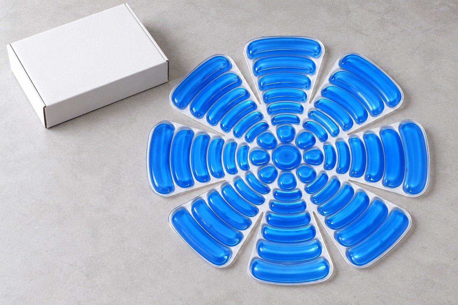 Blue ribbed PCM helmet liner laid flat beside a separate blank white box