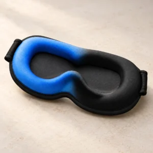 Blue-and-black contoured gel eye mask with recessed eye cups on a neutral surface