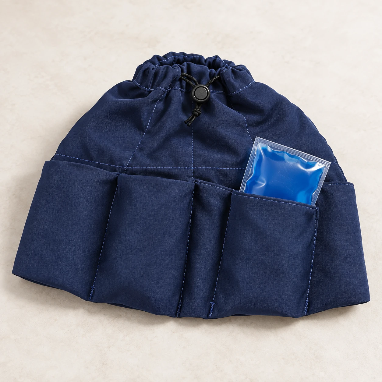 Navy pocketed head wrap with one blue gel insert partly withdrawn