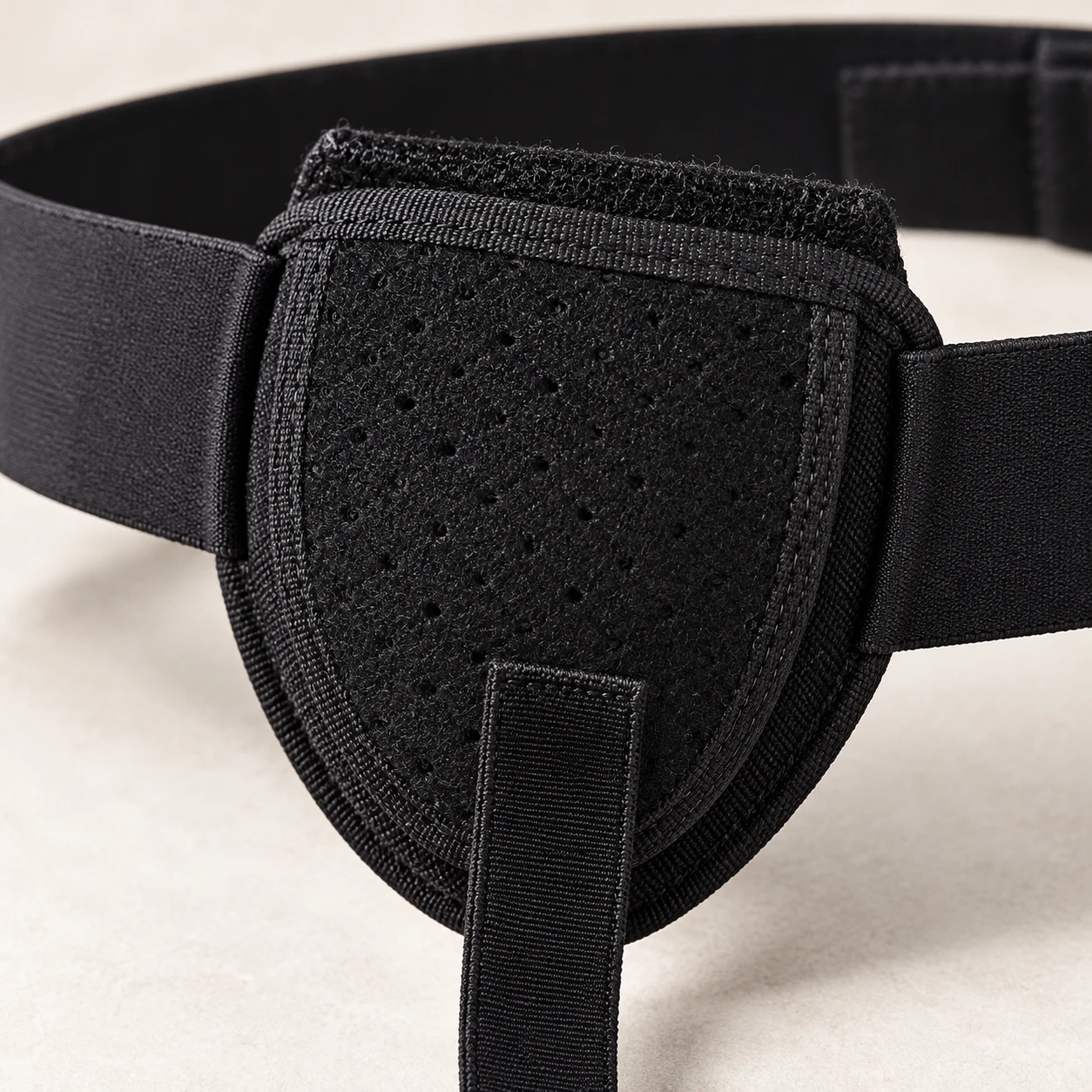 Close view of the bound front pocket and fastening area on a black belt