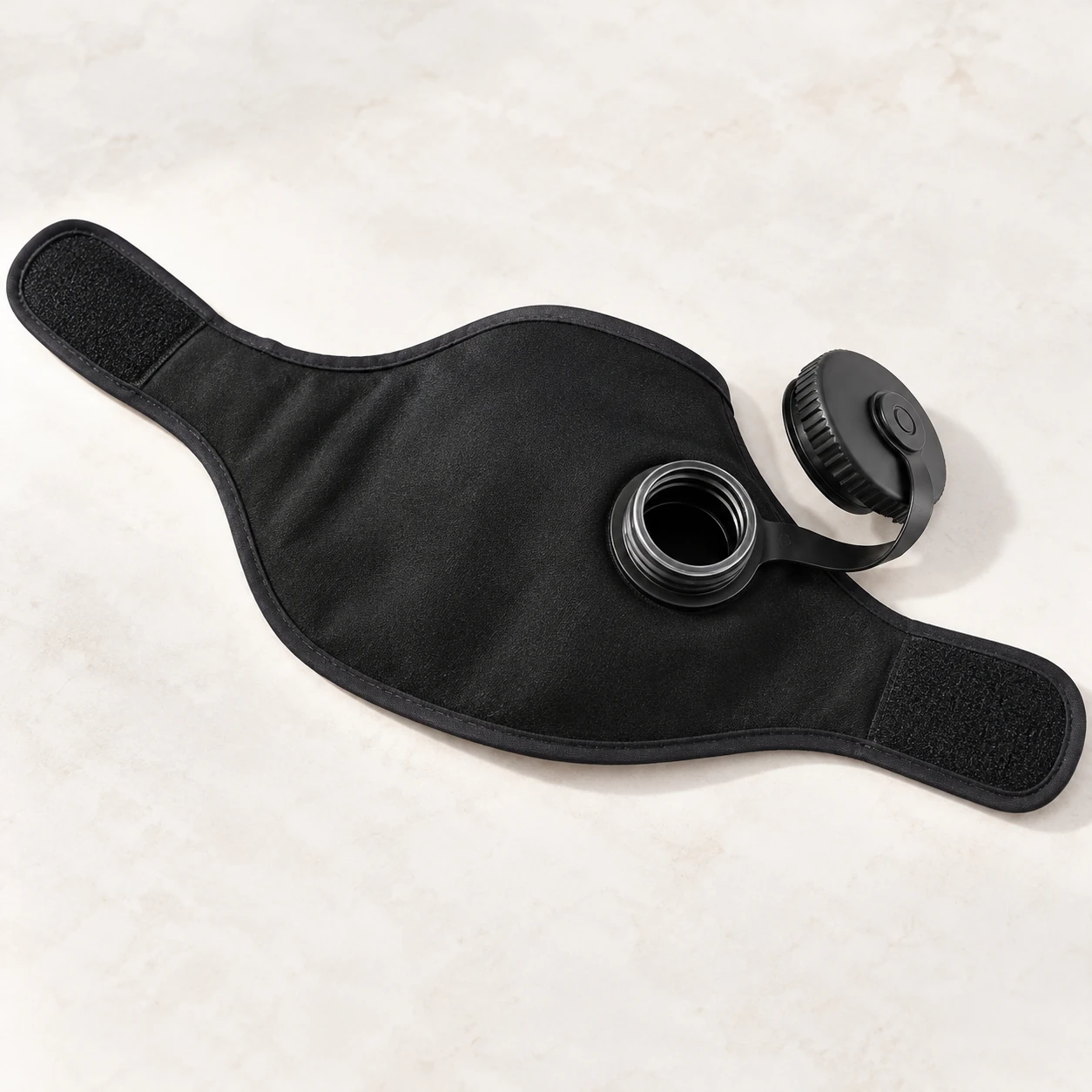 Opened-flat neck wrap showing its front wings and tethered screw cap
