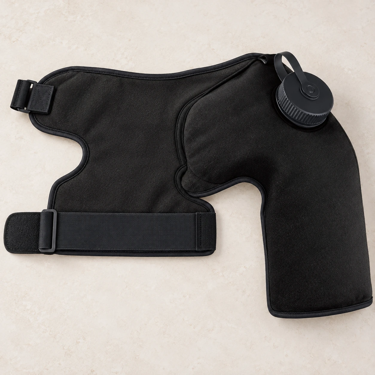 Opened-flat black shoulder wrap showing its contoured panel and chest strap